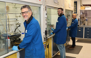 UDC chemists work on creating new phosphorescent OLED materials in a UDC lab.